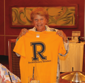 Marie Walsh models the reading with kids TShirt.