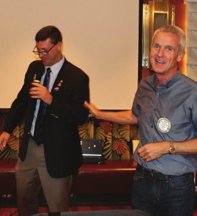 Past President Tom Thomas receives a recognition award from