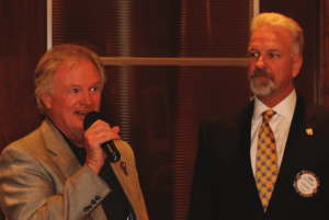 Sargent-at-Arms Kirk Alexander gives the mic to Tom Krob who brought us up to date on the Santa Clothes event