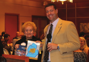 President Dave exchanges flags with two visiting rotarians.