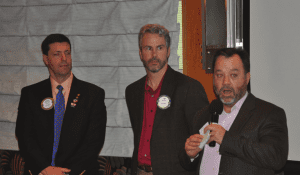 Jim Kohl presents a $3,500 check to Project 150.