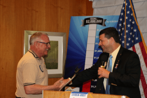 President Dave presents Ted McAdam with a Four Way Test Coin for his service to the club.
