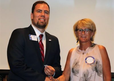 President Michael receives a pin from Catherine Mulnet Governor elect from district 1660 in France.