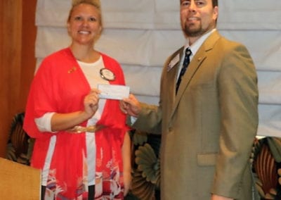 Jaime Goldsmith presented President Michael with a check towards our food can drive.