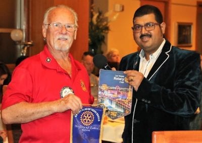 Robert Werner exchanged banners with a visiting International Rotarian.