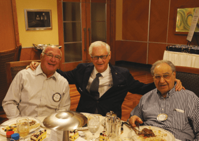 Three distinguished gentlemen, Messrs. Stieren, Rulffes and Fathie, enjoy lunch together.