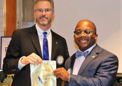 Joakim Nyoni presented President Jim with a banner from his homeland in Tanzania.