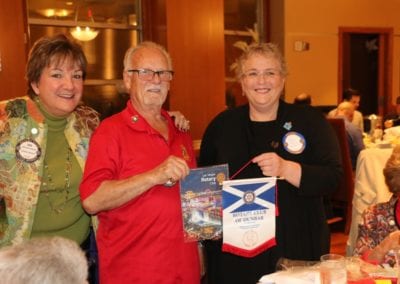Sergeant at Arms Deb Granda joined Bob Werner in exchanging Banners with a visitor from Scotland.