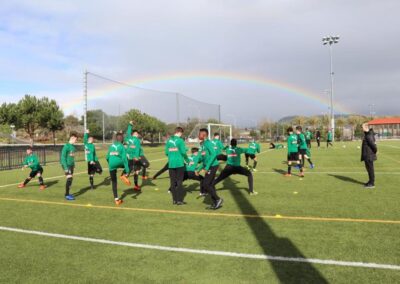 Players warming up at the Las Vegas Mayor's Cup below a rainbow
